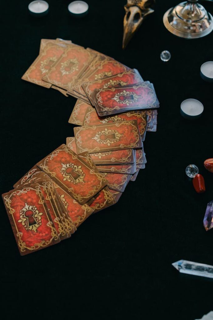 From above of fortune telling cards with candles and stones for seance and fortune telling